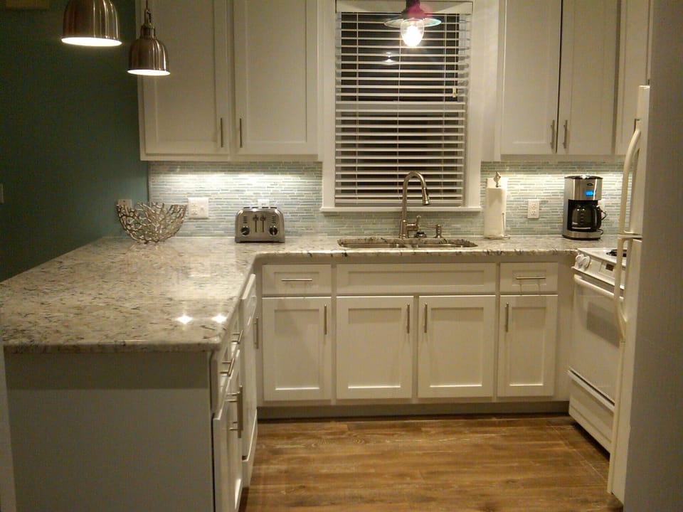 Another view of remodeled kitchen. New hardwood floors and lighting.