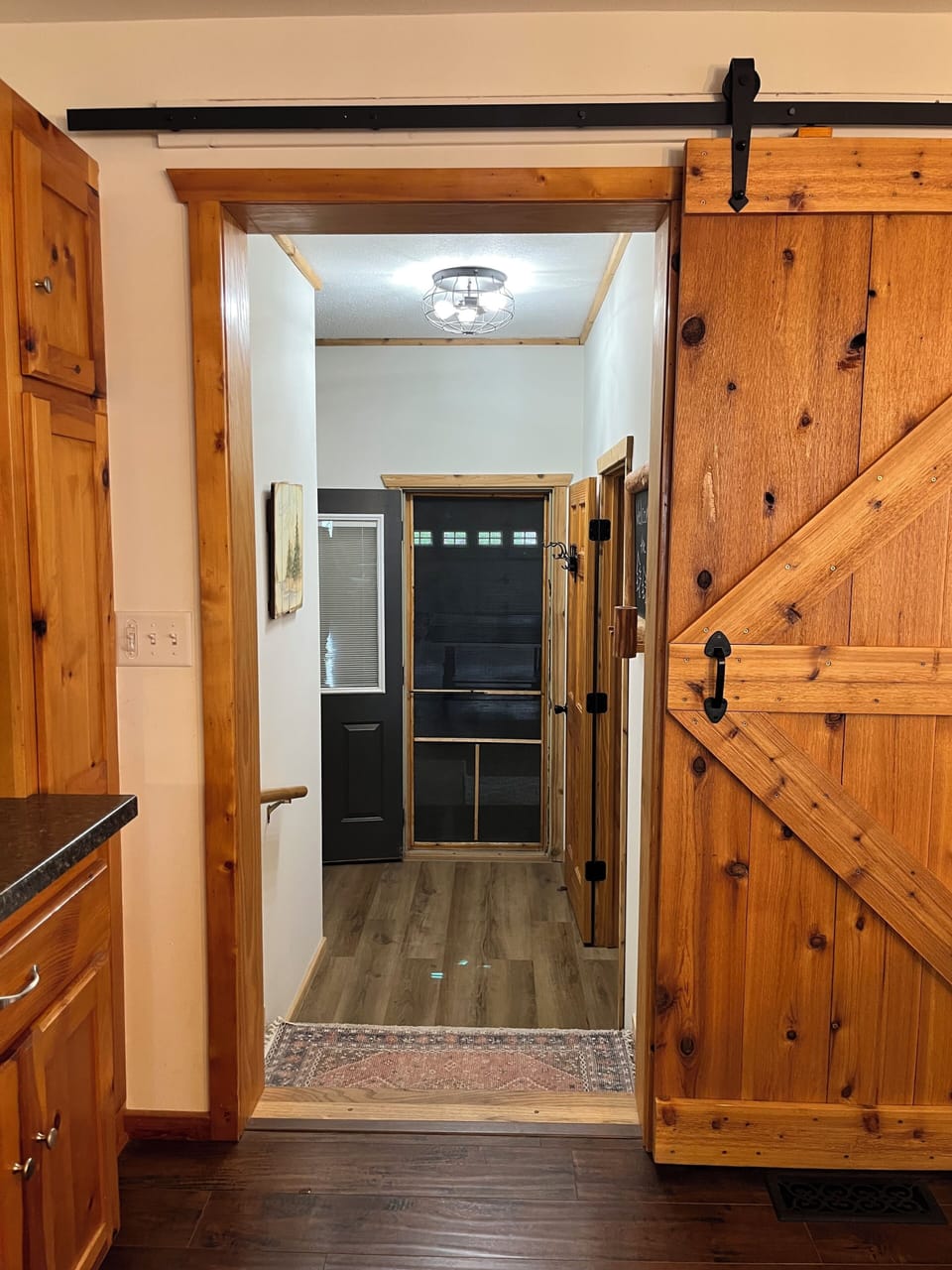 View from the kitchen into the foyer as it opens to the garage