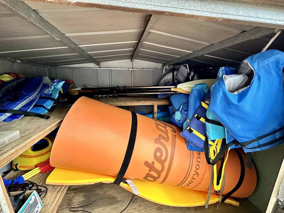 Shed by lake: Large 15' X 6' water mat, life jackets, floats/noodles, paddles