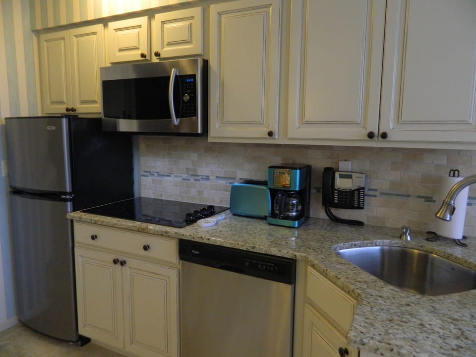 Kitchen with toaster, microwave/convection oven, dishwasher, cooktop,& coffeepot