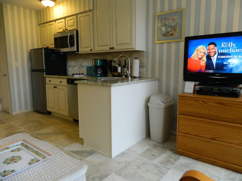 View of new kitchen, new tiled flooring & flat screen TV from living area