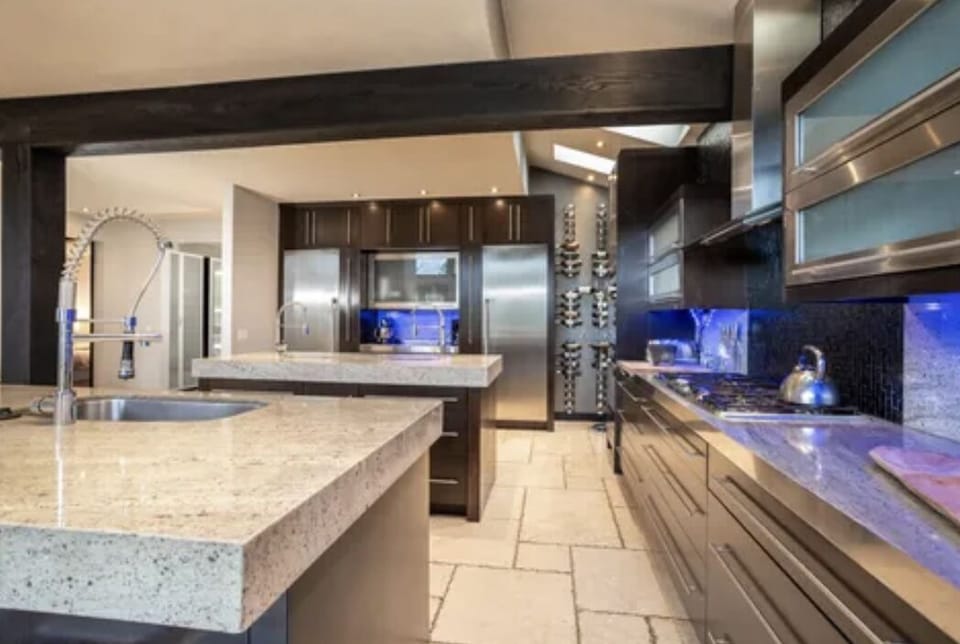 Kitchen has two islands with sinks, full sized fridge and freezer, 2 ovens