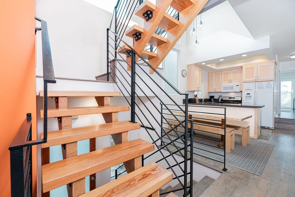 Central staircase leads up to top level bedrooms. One in front; one in the rear of condo.
                