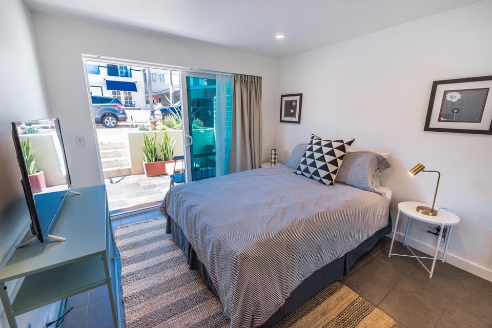 Lower level bedroom provides Queen bed, linens, Roku TV, closet, sliding glass door out to front sub-street patio and seating.
                