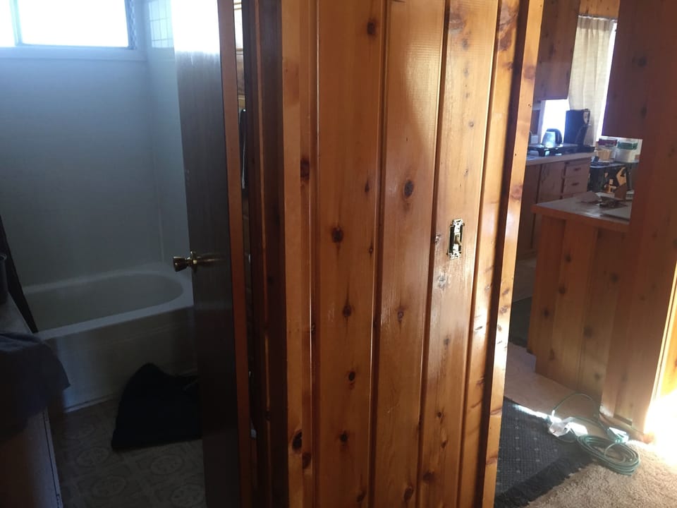downstairs bathroom on left and view into kitchen on right