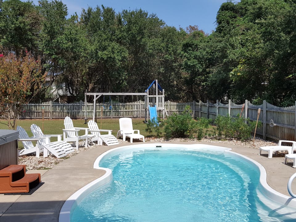 Cool off in the pool or relax in the hot tub. Kids will enjoy the playset.