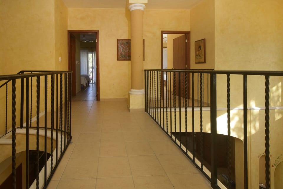 second level overlook walkway between the bedrooms