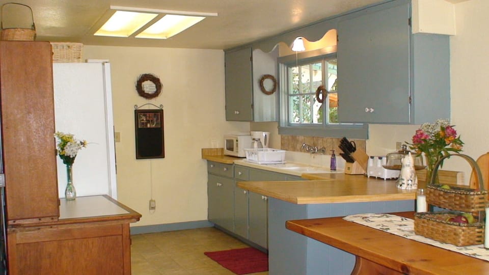 Complete country kitchen with antique hoosier, microwave, coffee and essentials