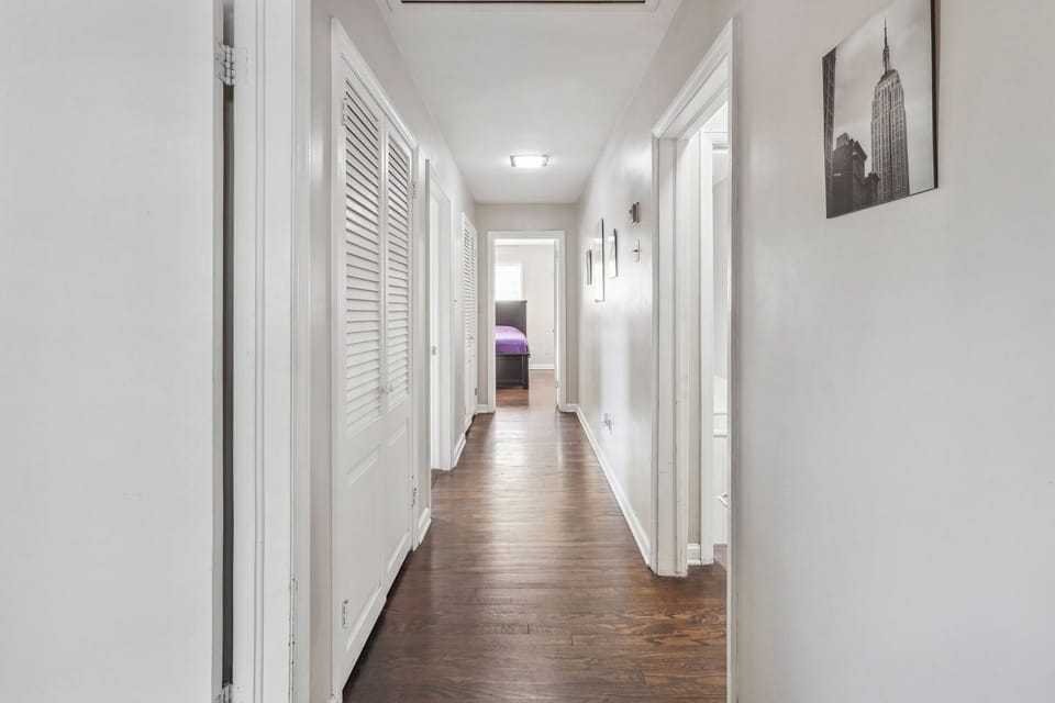 Main Level hallway to bathroom/bedrooms with guest closets