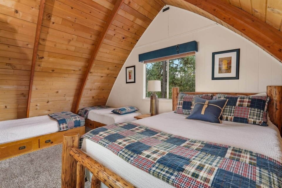 This bedroom includes a queen size bed and 2 twin beds. High quality mattresses and linens assure a comfortable sleep. This room also includes a SMART TV and has a window mounted A/C unit installed May through October.