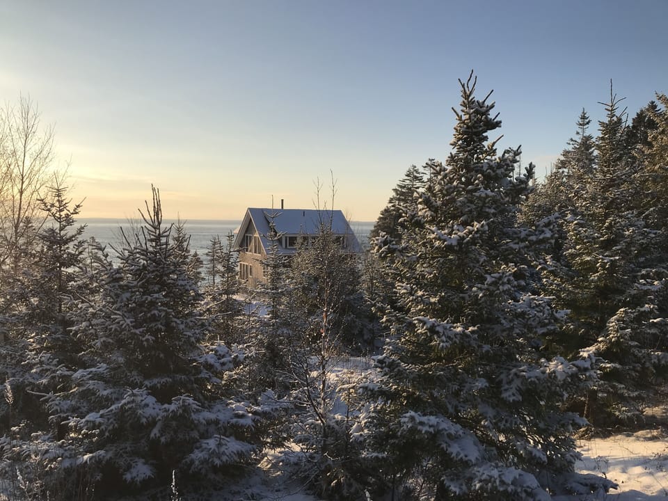The house on a winter day from above.  Penobscot Bay beyond.