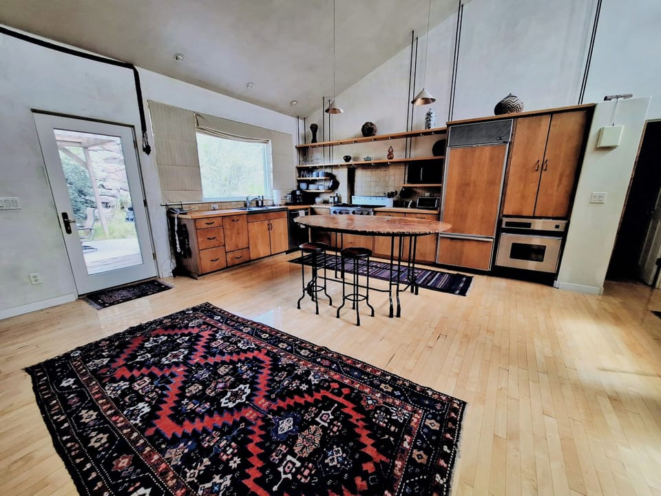 Kitchen with new oven, stainless steel dishwasher, and large gas range stovetop