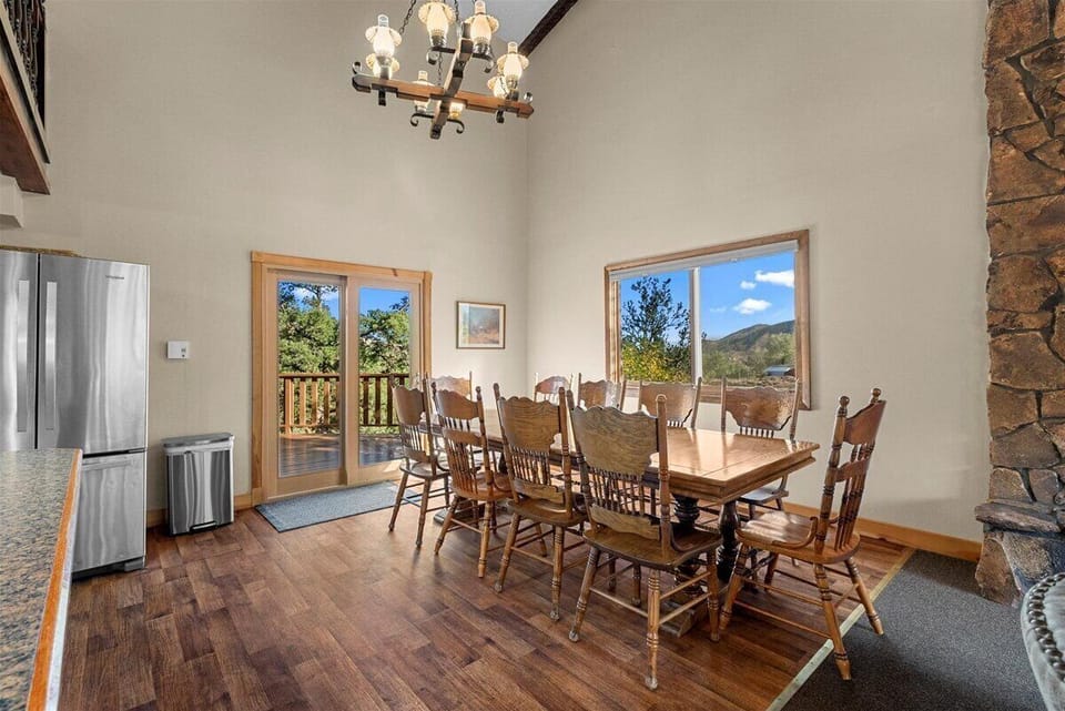 Dining table with a door leading to the back deck.
