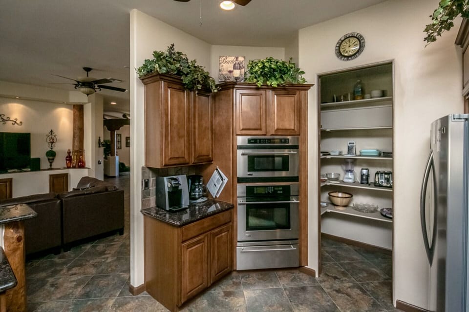 Kitchen off of family room with open floor plan and spacious, equipped pantry.
