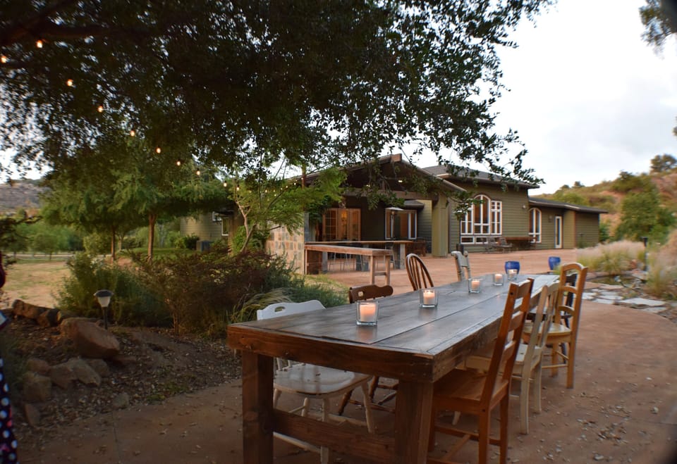 Dining under the Oak trees on a handmade Farm Table.
