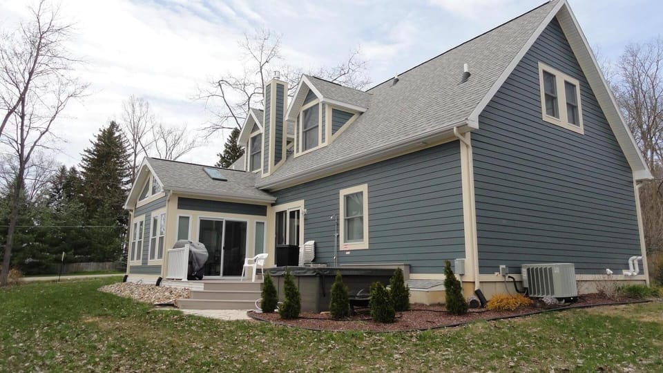 Rear View - Outdoor deck, hot tub, outdoor shower and gas barbecue grill.