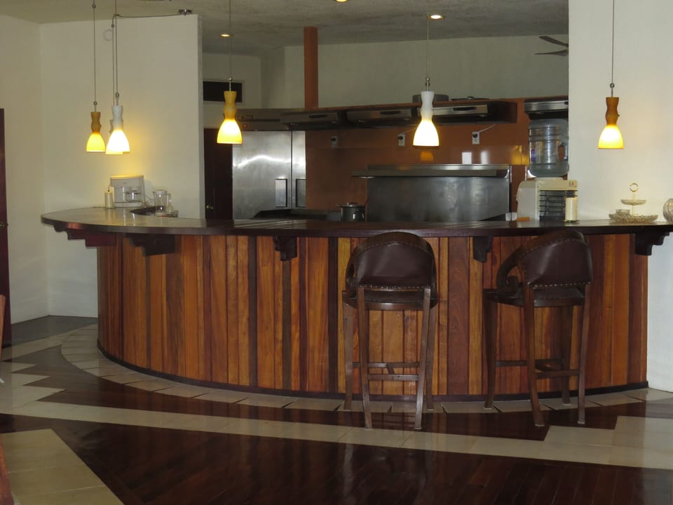Bar with kitchen area behind.