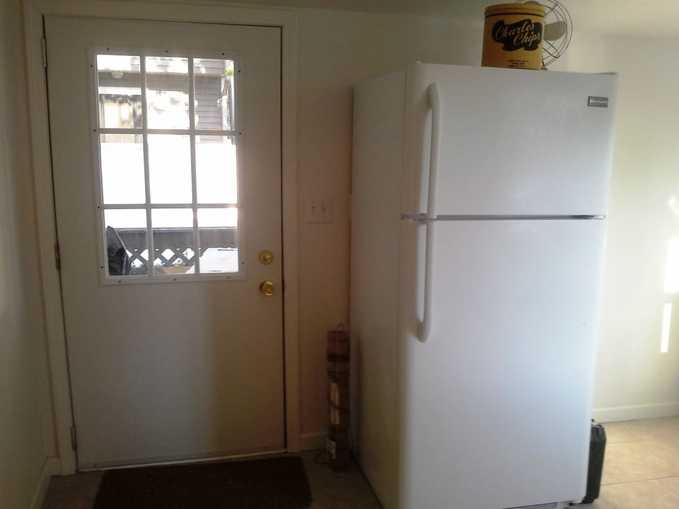 Back door to shady yard with propane BBQ.