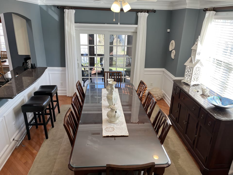  Dining room view with slider leading to right screened-in porch.