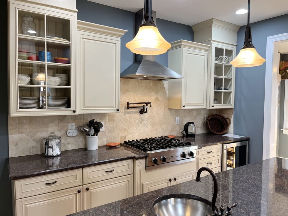 Plenty of dishes, glassware, and serving utensils. Handy extra sink in island.