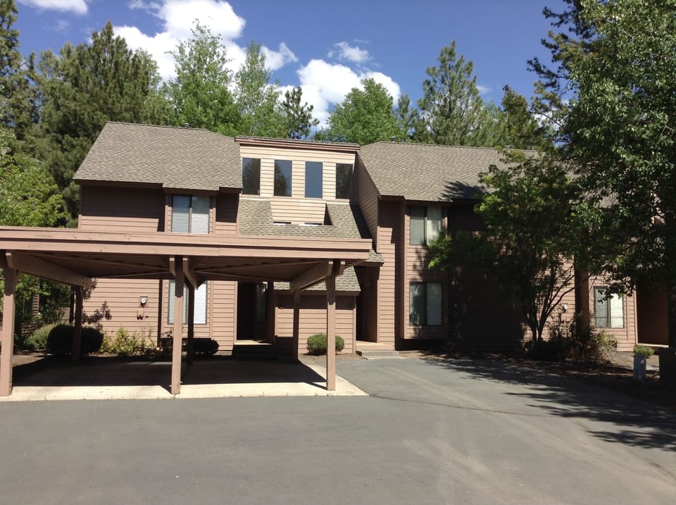 Exterior with shared carport on the right and additional parking