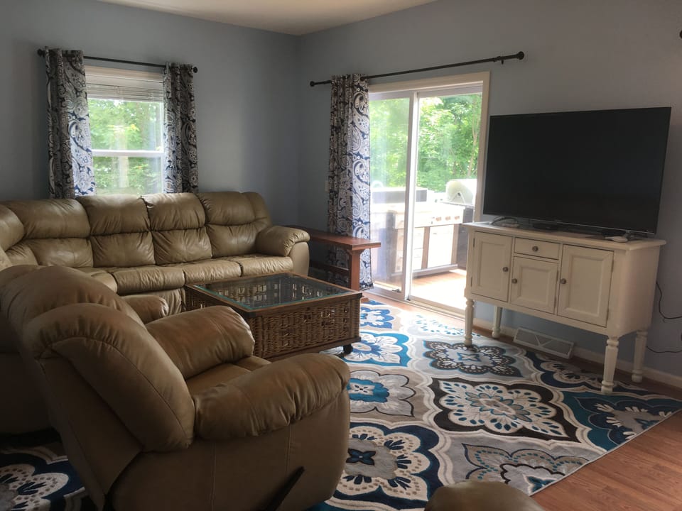Comfy seating in the living room. All TV's are new with Xfinity service.