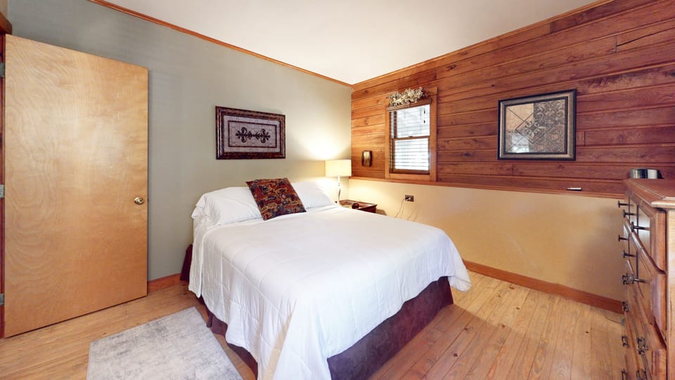 First queen bedroom off main level with smart tv and closet space.