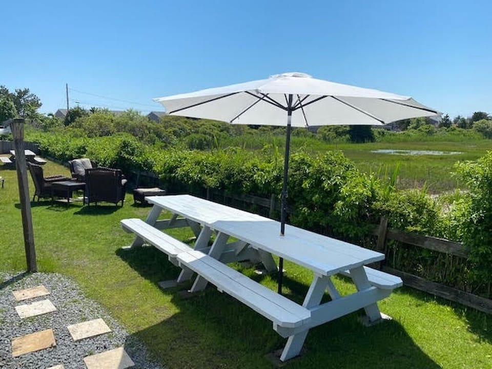 Two picnic tables with lots of seating for outdoor dining