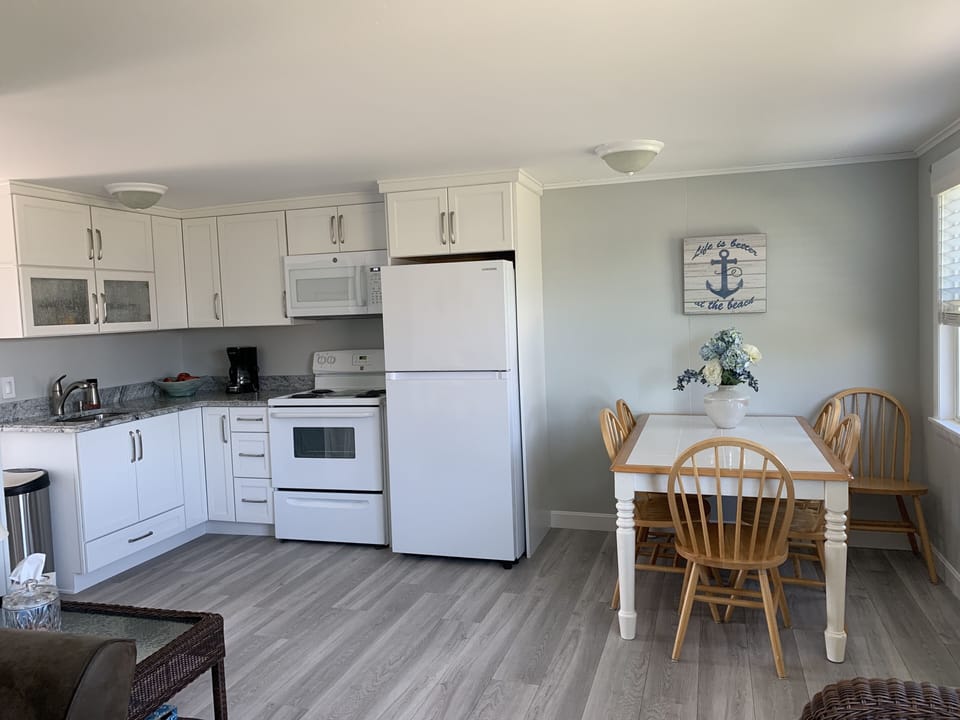 Kitchen- NEW floors, cabinets, fridge, stove & microwave (view from living room)