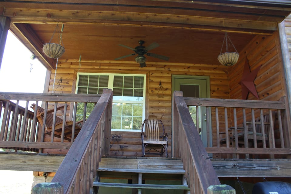 Porch with swing and rockers.