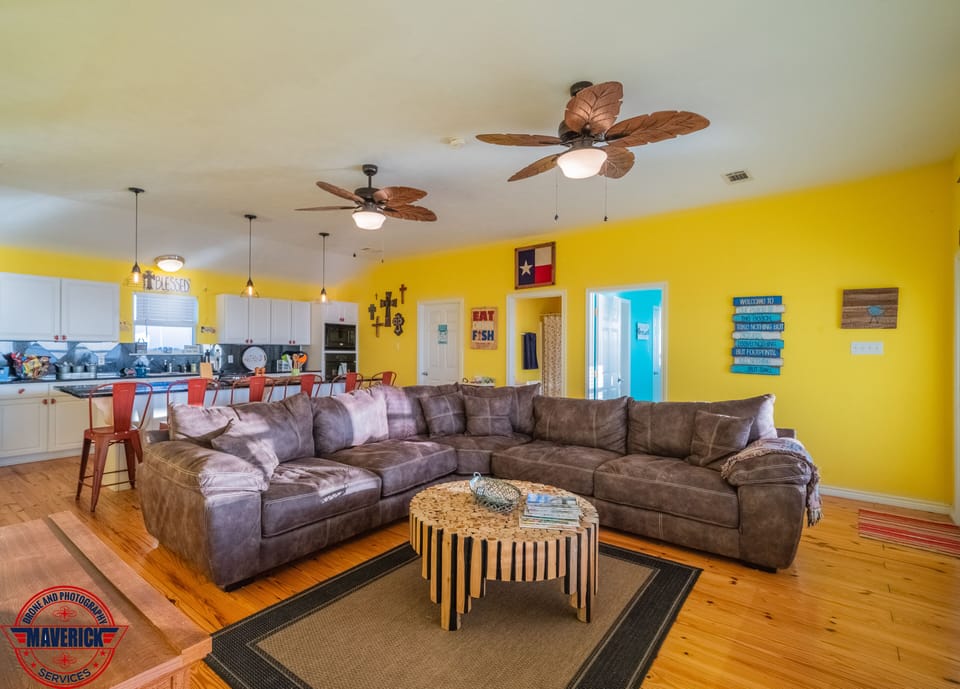 Living area with comfy sectional and amazing window views of Rollover Bay.
