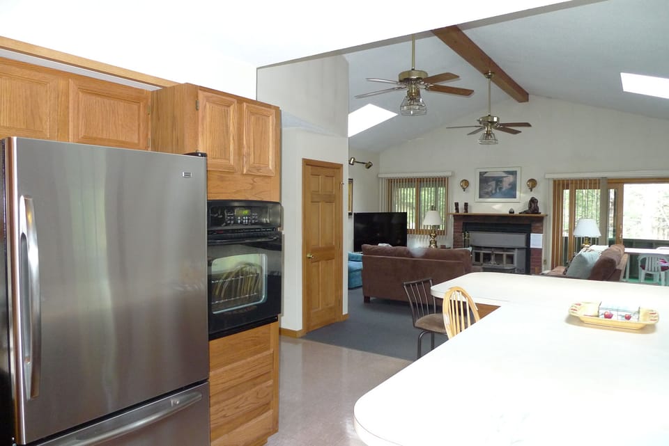 Kitchen breakfast bar seats 8, and is adjacent to living room