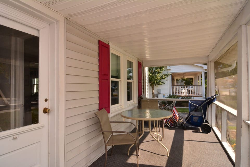 Large screened-in porch with ample seating and Beach Equipment Available for our Guests.