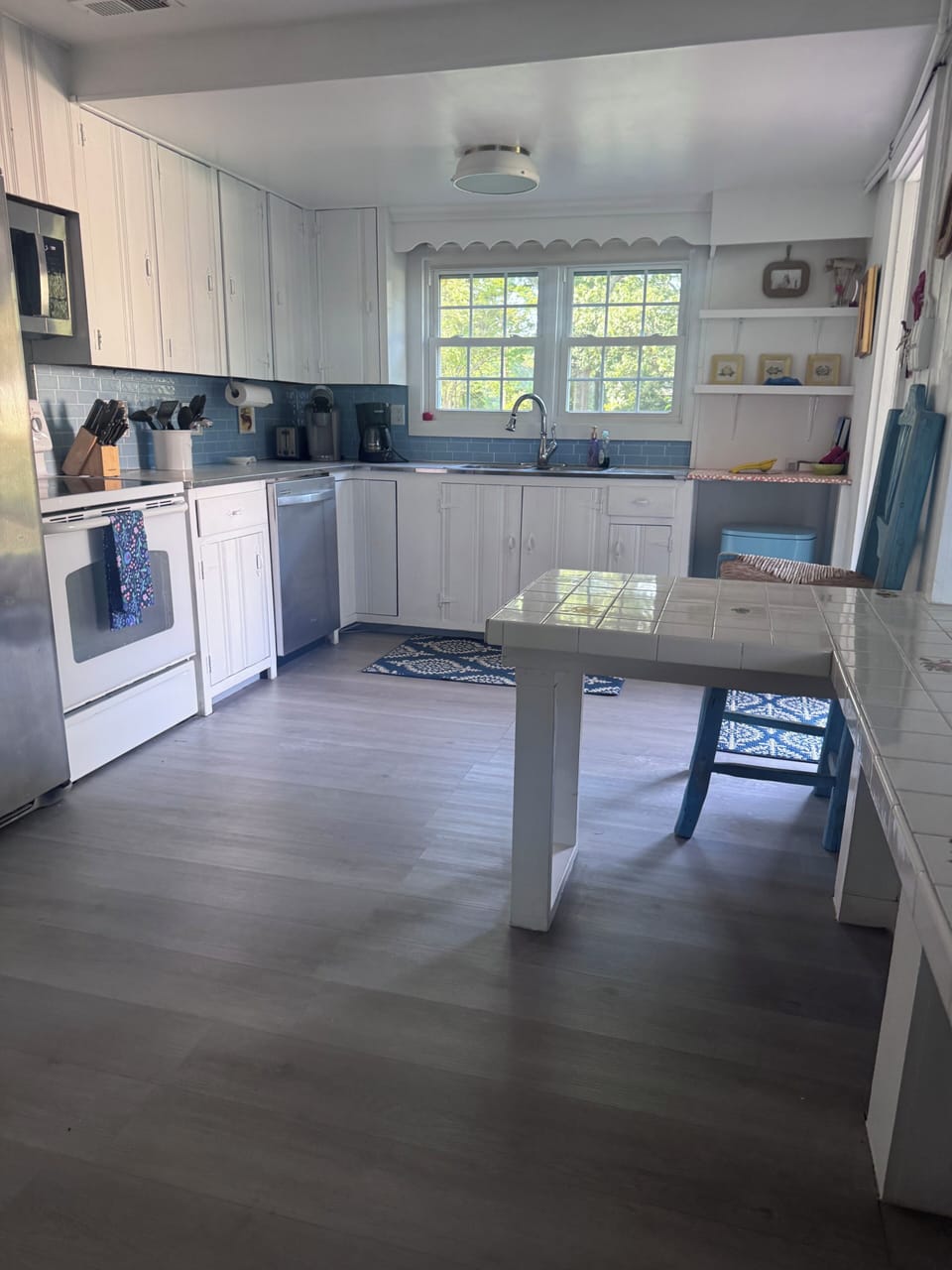 Fully stocked kitchen with island and seats for eating or gathering around