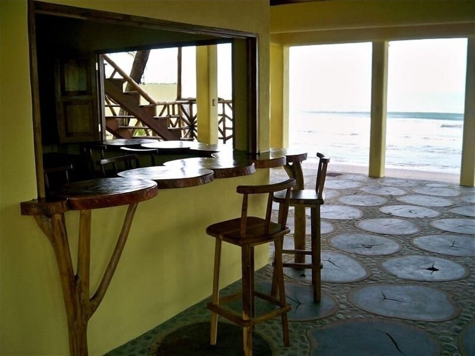 Bar overlooking ocean and sand bottom beach break.
