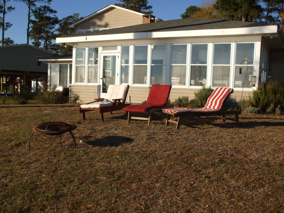 River side of house, larger sunporch and fire pit