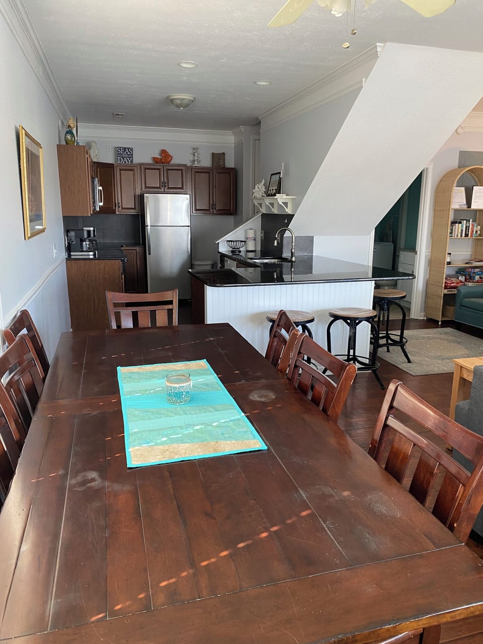 Dining table with kitchen in distance.  Table seats 8 and bar seats 5.