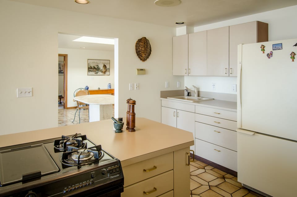 looking from kitchen to living room. Gas range.