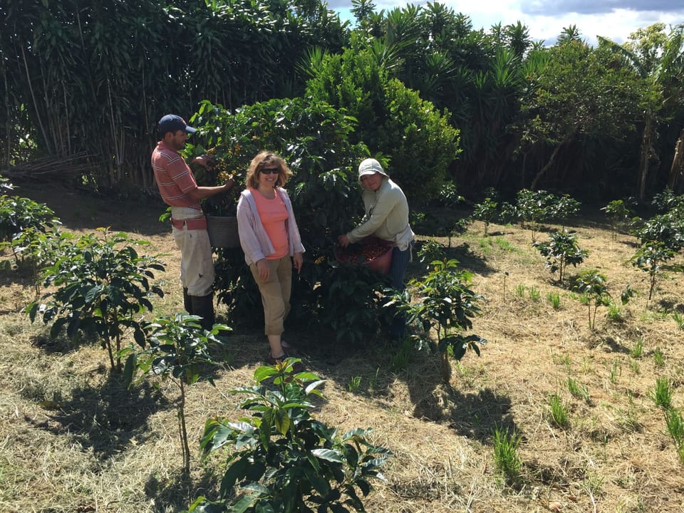 Kim in field with Jose and Yoleni