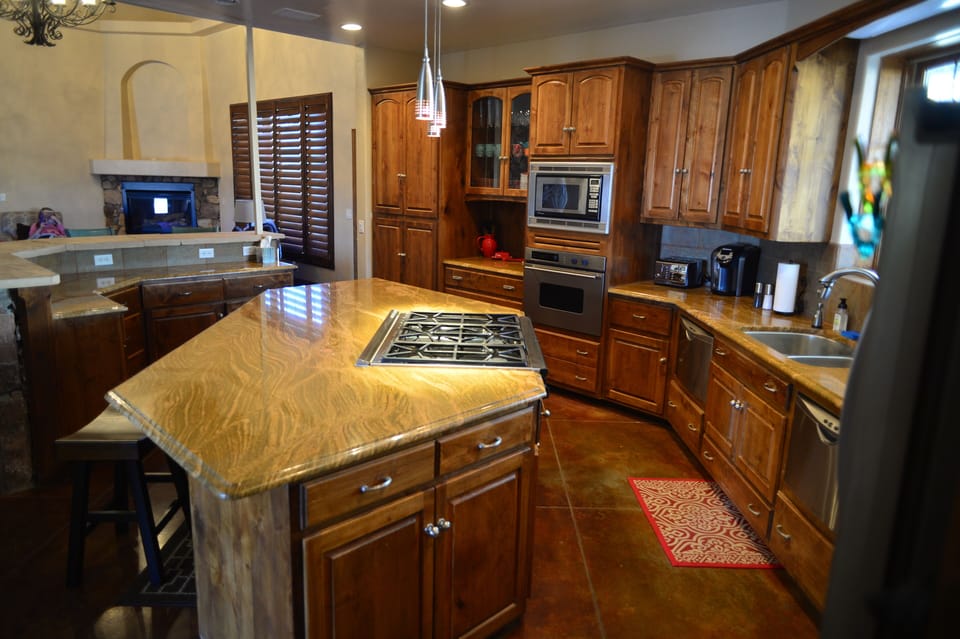Gourmet kitchen with 6 burner stove, granite counters, and beautiful cabinetry.