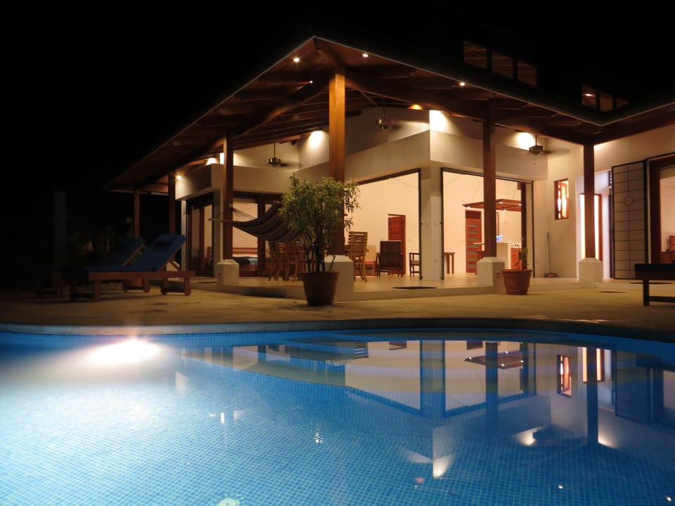 House and pool at night
