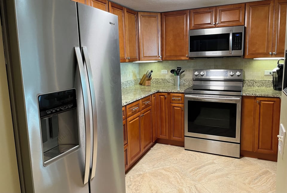 Maple cabinets and granite countertops and new stainless steel appliances.  
