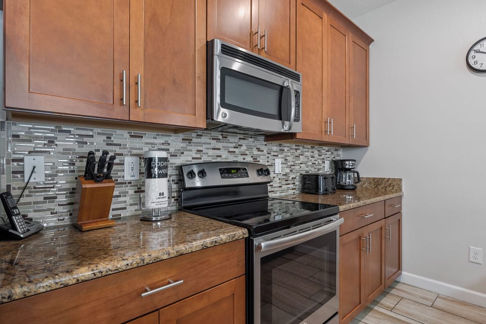 Fully stocked kitchen includes toaster and coffee maker.