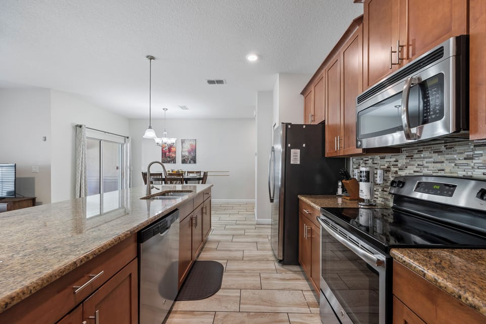 Fully stocked kitchen with dishwasher, stove, oven, microwave, refrigerator, etc