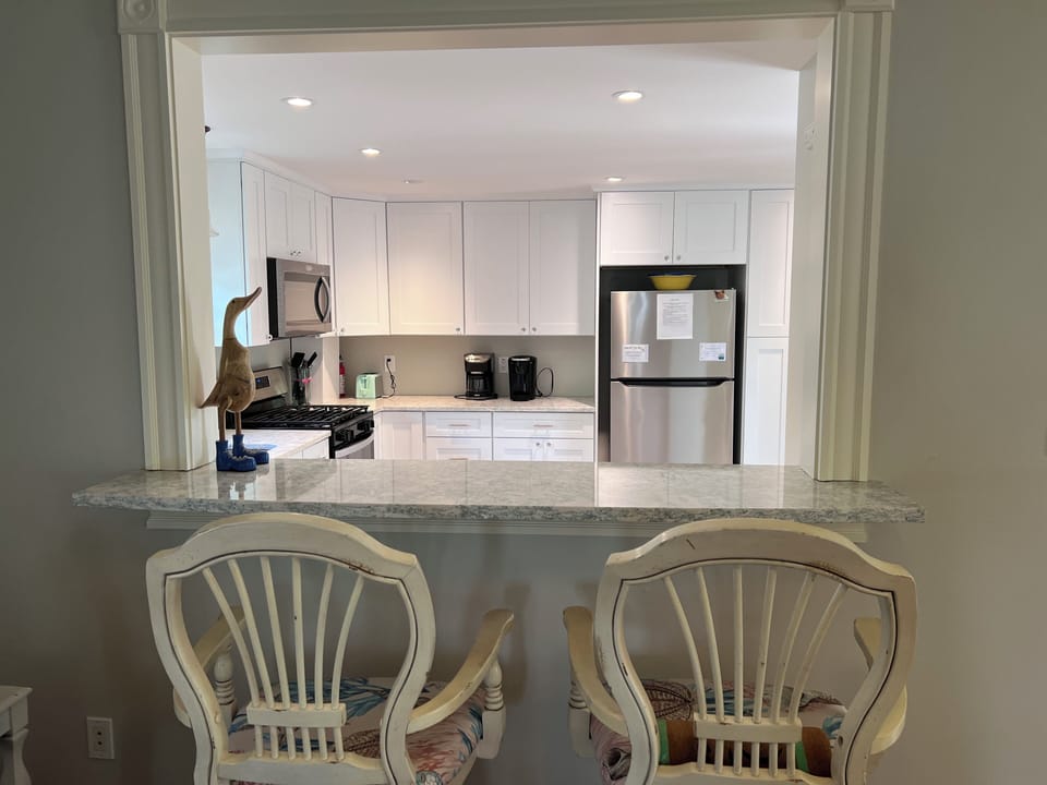 New eat in breakfast bar area with two stools.