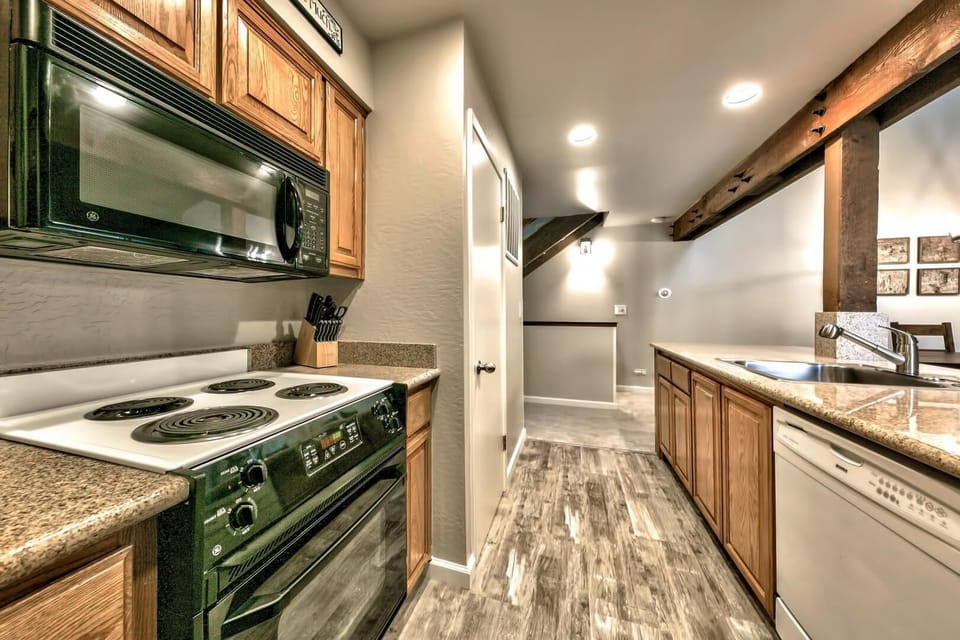 Kitchen includes electric stove and oven, microwave, full sized refrigerator/freezer, and dishwasher