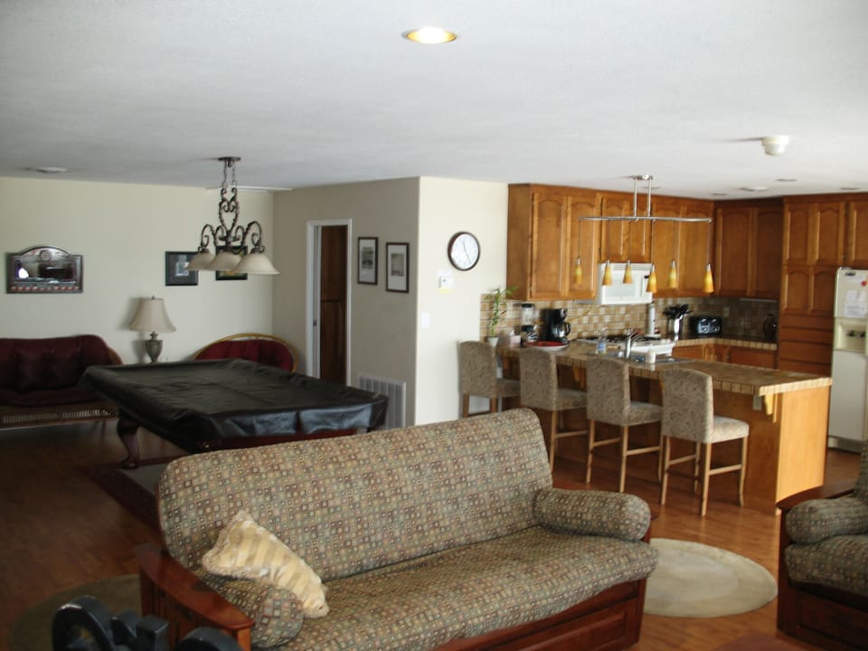 Living room, pool table and kitchen