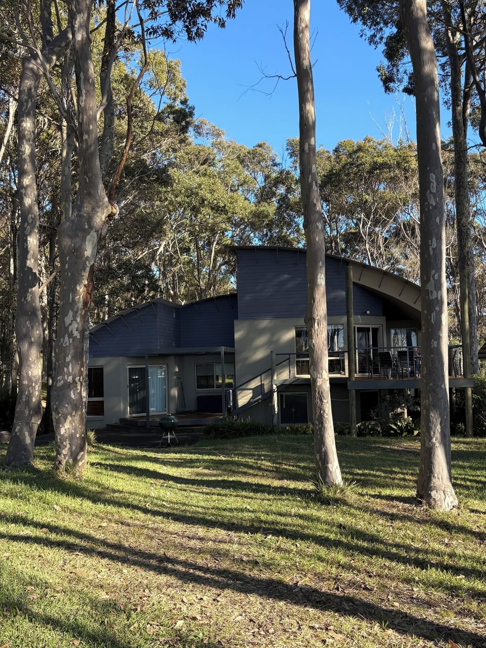 The back of the house looks to the ocean across lawn