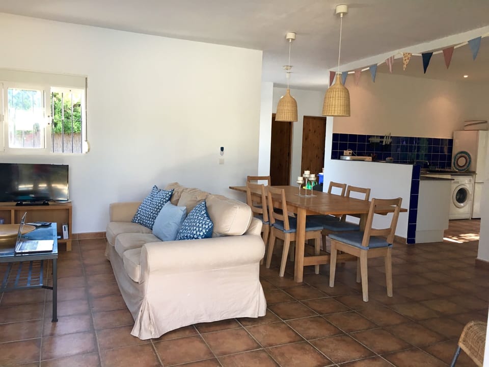 The dining, kitchen and soft seating form one open living area
