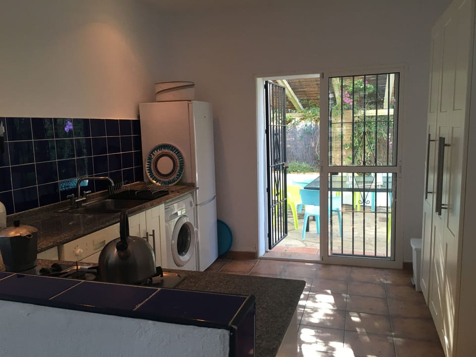 Looking out to the covered dining terrace through the kitchen at Casa Curvda